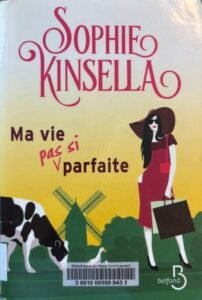 Couverture de Ma vie pas si parfaite de Sophie Kinsella : des couleurs vives mettent en scène une citadine élégante en robe rouge et capeline dans la campagne.